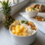 Delicious cottage cheese pineapple protein bowl served in a white bowl.