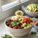 Featured image of a beautifully styled ground beef cauliflower taco bowl.