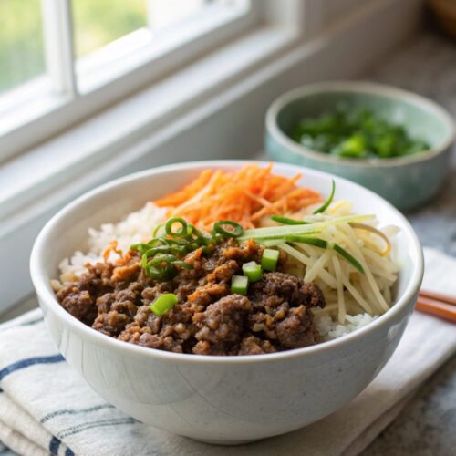 Hero image showcasing the vibrant and delicious Korean Ground Beef Bowl topped with sesame seeds and served in a clean bowl.
