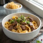 Featured image of easy beef stroganoff recipe, beautifully served in a bowl.