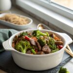 Low-carb beef broccoli skillet served hot in a skillet, garnished with sesame seeds