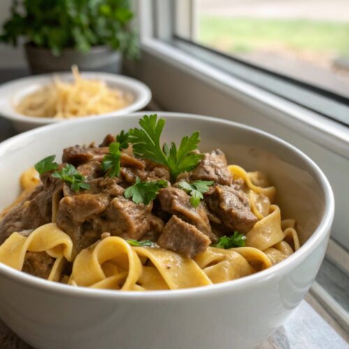 Easy beef stroganoff served in a bowl, garnished with parsley