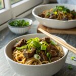 Close-up of delicious slow cooker Korean beef noodles served in a bowl.