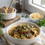 A delectable serving of authentic beef stroganoff recipe in a white bowl