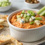 Buffalo Chicken Dip Recipe featuring a vibrant dip garnished with green onions