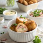 Golden Chicken Cordon Bleu Bites served on a plate with garnish