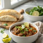 Savory Crockpot Birria de Res served simply garnished in a white bowl.