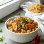 Plate of delicious homemade hamburger helper with a garnish of parsley