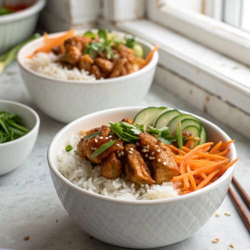 A mouth-watering photo of sticky chicken rice bowls served in a white bowl.