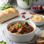 A comforting image of slow cooker beef Manhattan served with mashed potatoes and gravy.