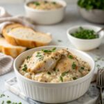 Savor the Creamy Smothered Chicken and Rice dish, perfectly plated with rich sauce and fresh garnish.