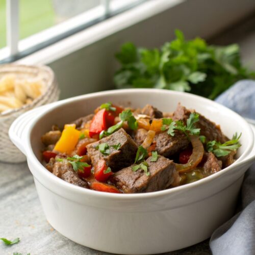 A plated, finished dish of crock pot pepper steak ready to enjoy