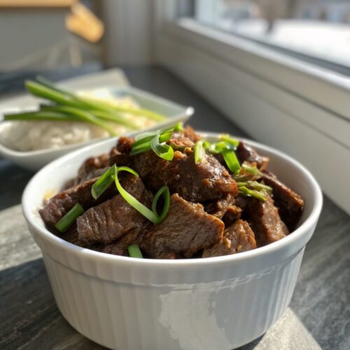 A beautifully plated serving of Crockpot Mongolian Beef with vibrant ingredients.