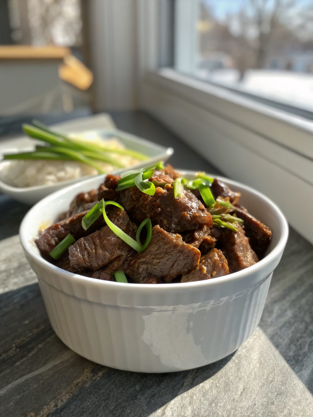 A beautifully plated serving of Crockpot Mongolian Beef with vibrant ingredients.